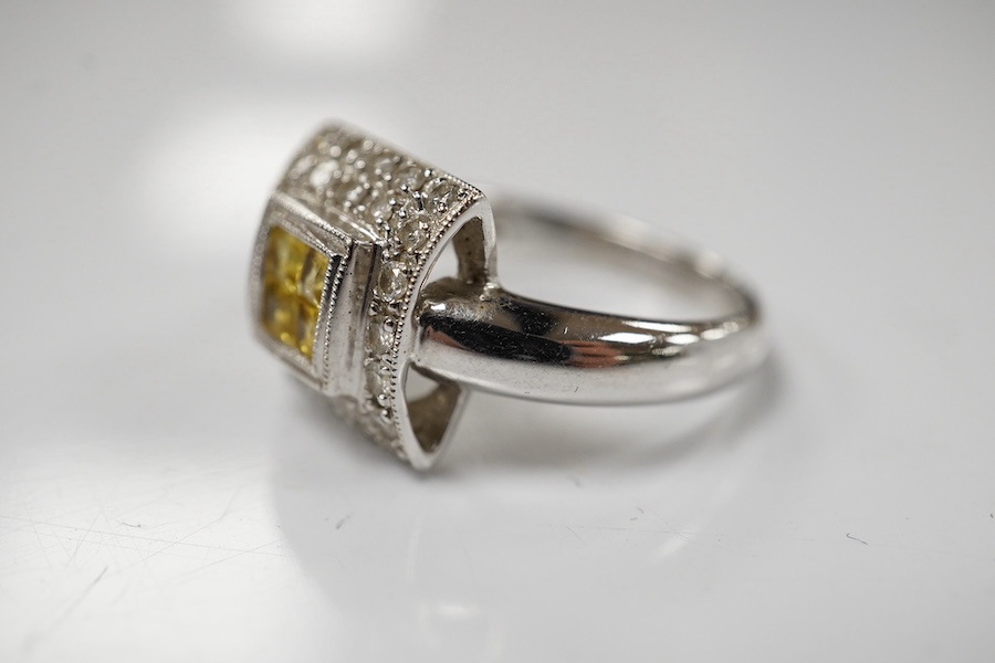 A modern 18ct white gold, yellow sapphire and diamond chip set square cluster ring, size N/O, gross weight 5.1 grams. Condition - fair to good